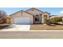 Single-story home with a two-car garage and low-maintenance desert landscaping at 5050 Nw Valdez Ct, Pahrump, NV 89060