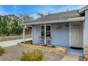 Cozy front porch with small table and chairs, surrounded by tidy landscaping and a charming blue exterior at 533 K Ave, Boulder City, NV 89005