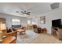 Spacious living room with hardwood floors, comfortable seating, and an open layout into the dining area at 533 K Ave, Boulder City, NV 89005