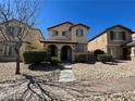 Charming two-story home featuring manicured front yard, desert landscaping, and covered porch at 5721 Heineken Dr, North Las Vegas, NV 89031