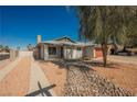 Charming single-story home with desert landscaping, inviting walkway, and a classic brick chimney at 6284 Pinewood Ave, Las Vegas, NV 89103