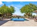 Enjoy this backyard rectangular pool and lush landscape with desert and mountain views at 66 Golf Estates Dr, Las Vegas, NV 89141