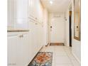 Hallway with ample storage cabinets, updated tile flooring, and closet at 737 Oakmont Ave # 1202, Las Vegas, NV 89109