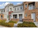 Inviting townhome exterior with stone accents, a covered entryway, and well-maintained landscaping at 7544 Nicklin St, Las Vegas, NV 89143