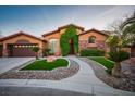 Beautiful single-story home with well-manicured front yard and lush landscaping at 7685 Gilespie St, Las Vegas, NV 89123