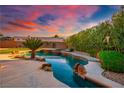 Beautiful backyard oasis with a sparkling swimming pool, lush landscaping, and ample space for entertaining at 7685 Gilespie St, Las Vegas, NV 89123