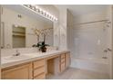 Bright bathroom featuring a double sink vanity with a large mirror and a shower-tub combination at 908 Domnus Ln # 203, Las Vegas, NV 89144