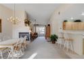 Spacious living area with a fireplace, ceiling fan, breakfast bar, and dining area with natural light at 908 Domnus Ln # 203, Las Vegas, NV 89144