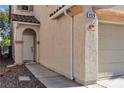 Inviting front entrance featuring an arched doorway, textured walls and manicured stone landscaping at 9526 Vast Valley Ave, Las Vegas, NV 89148