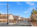 Community entrance with security gate, manicured landscaping, and access road into a secure neighborhood at 9555 Belle Fountain Ave, Las Vegas, NV 89123