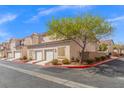 Townhome with two-car garage, lush landscaping, set in a well-maintained community at 9555 Belle Fountain Ave, Las Vegas, NV 89123
