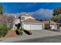 Charming two-story home featuring a red tile roof and a spacious two-car garage at 2864 Cape Verde Ln, Las Vegas, NV 89128