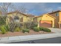 Inviting single-Gathering home featuring a well-kept yard and a two-car garage at 10632 Open Range Ct, Las Vegas, NV 89179