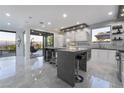 Stylish kitchen featuring a large island, modern cabinetry, and stainless steel appliances at 1168 Spago Ln, Henderson, NV 89052