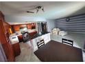 Open-concept kitchen and living area with granite countertops, stainless steel appliances, and marble flooring at 1208 Lucia Dr, Las Vegas, NV 89128