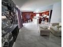 Open-concept living space seamlessly connects kitchen with granite countertops, stainless appliances and dining area at 1208 Lucia Dr, Las Vegas, NV 89128