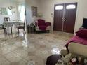 Inviting living room featuring neutral tones, tile floors and an open floor plan at 1320 Norman Ave, Las Vegas, NV 89104