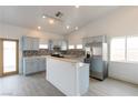 Kitchen with stainless steel appliances, light blue cabinets, breakfast bar, and mosaic backsplash at 2128 La Salle St, Las Vegas, NV 89106