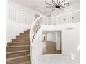 Bright foyer showcases a staircase with white railings and wood steps, leading to an upper level at 3021 Ocean Port Dr, Las Vegas, NV 89117
