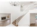 Open staircase bathed in natural light, featuring a contemporary chandelier and minimalist design at 3021 Ocean Port Dr, Las Vegas, NV 89117