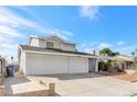 The home features a three-car garage and low-maintenance front yard landscaping at 3547 Rosewood St, Las Vegas, NV 89103