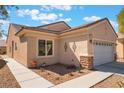 Well-maintained home with a two-car garage, desert landscaping, and stucco exterior at 3603 Herring Gull Ln, North Las Vegas, NV 89084