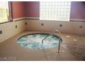 A luxurious indoor hot tub with clear blue water, offering a relaxing and private spa-like experience at 3603 Herring Gull Ln, North Las Vegas, NV 89084