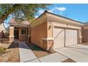 Inviting single-story home with neutral stucco, brick accents, and attached garage; a cozy entrance at 3608 Herring Gull Ln, North Las Vegas, NV 89084