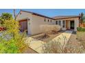 Inviting single-story home with a tile roof, a two-car garage, and landscaped front yard at 3649 Starlight Ranch Ave, North Las Vegas, NV 89081