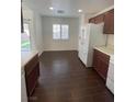 Bright kitchen featuring ample cabinet space, stainless steel appliances, and backyard access at 4236 Thomas Patrick Ave, North Las Vegas, NV 89032