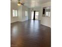 Spacious living room with tile floors, ceiling fan, and sliding glass door to backyard at 4236 Thomas Patrick Ave, North Las Vegas, NV 89032