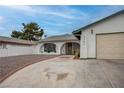 Charming single-story home featuring a low-pitched roof, arched entry and a two-car garage at 4323 E Twain Ave, Las Vegas, NV 89121