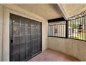 Private balcony featuring double glass doors, terra cotta tile and ornate wrought iron at 5070 Jeffreys St # 101, Las Vegas, NV 89119