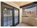 Private balcony featuring double glass doors, terra cotta tile and ornate wrought iron at 5070 Jeffreys St # 101, Las Vegas, NV 89119