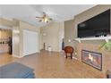 Open living space with tile flooring, a fireplace, and seamless access to the kitchen at 5335 Duralite St # 203, Las Vegas, NV 89122
