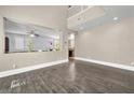 Bright living room with hardwood floors, modern lighting, and an open-concept design at 5351 Glenburnie St, Las Vegas, NV 89122