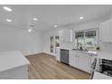 Bright kitchen featuring white cabinets, stainless steel appliances, and a modern aesthetic at 57 Marion Dr, Las Vegas, NV 89110
