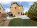 Spacious backyard with a patio area, artificial turf, and low-maintenance landscaping at 6030 Hidden Summit St, North Las Vegas, NV 89031
