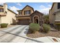 Charming two-story home features a stone-accented entrance, attached garage, and a well-maintained front yard at 6030 Hidden Summit St, North Las Vegas, NV 89031
