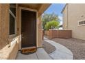 Inviting front entrance with a decorative walkway and a charming 'Don't Stop Believing' welcome mat at 6030 Hidden Summit St, North Las Vegas, NV 89031