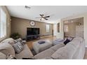 Inviting living room with a comfortable sectional sofa, large TV, and neutral color palette at 6030 Hidden Summit St, North Las Vegas, NV 89031