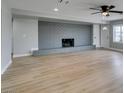 The spacious living room boasts a gray brick fireplace, neutral paint, new light wood flooring, and plenty of space at 1013 Cunningham Dr, Las Vegas, NV 89106