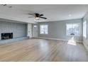 Bright, open living room features light wood floors, painted brick fireplace, ceiling fan, and ample natural light at 1013 Cunningham Dr, Las Vegas, NV 89106