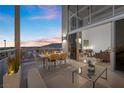 Outdoor patio showing sliding glass door to living room and outdoor dining set with city views at 11441 Allerton Park Dr # 212, Las Vegas, NV 89135