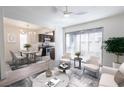 Inviting open-concept living room with ceiling fan and access to the dining area and kitchen at 1405 Vegas Valley Dr # 247, Las Vegas, NV 89169