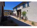 Exterior view of a modern townhome featuring stone accents, desert landscaping and private entrance at 20 Barbara Ln # 25, Las Vegas, NV 89183