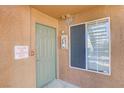 Unit entrance with door, alarm box and window, set in a textured wall at 2120 Ramrod Ave # 1318, Henderson, NV 89014