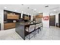 Contemporary kitchen featuring a center island, stainless steel appliances, and custom wooden cabinetry at 2819 Queens Courtyard Dr, Las Vegas, NV 89109
