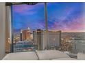 Expansive city view featuring the city skyline at sunset from inside the home at 3726 Las Vegas Blvd # 2407, Las Vegas, NV 89158