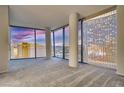 Bright, open space with floor-to-ceiling windows showcasing views of the cityscape during sunset at 3726 Las Vegas Blvd # 2506, Las Vegas, NV 89158